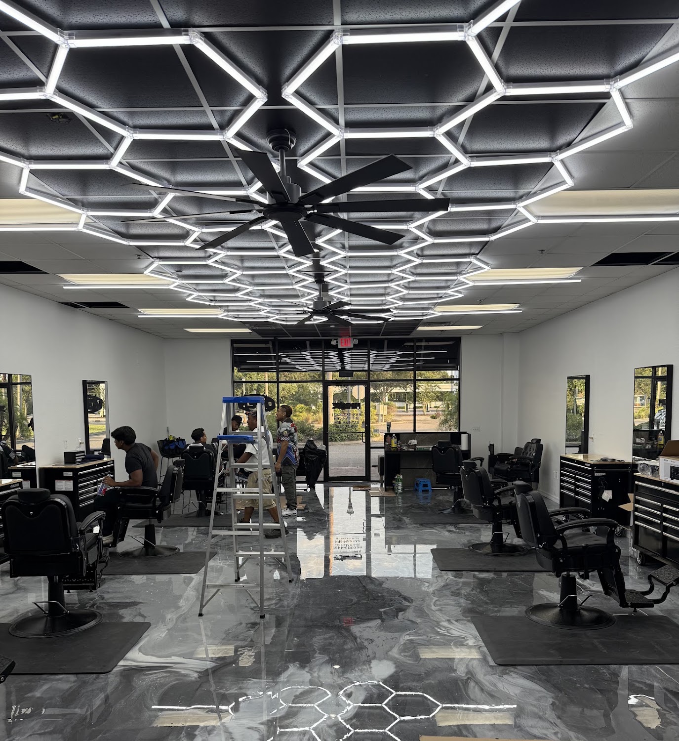 The Prime Cutz floor: a hexagonal grid of LED light bars across the ceiling above a polished marble-effect floor